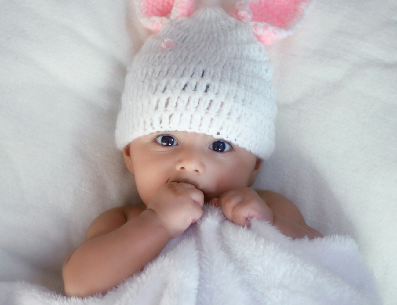 Newborn asleep in a Baby Ocean swaddle