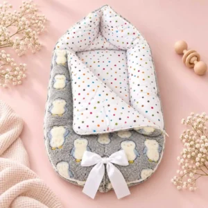Grey penguin baby carry nest with padded sides polka dot lining wrap blanket and white bow